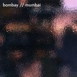 The song title atop a view to a distant city through frosted glass.