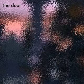 The song title atop a view to a distant city through frosted glass.